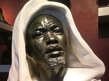 Salem, Negro of Sudan sculpture showing a dark-toned male figure with a short beard, an upward gaze, and a flowing hooded garment.