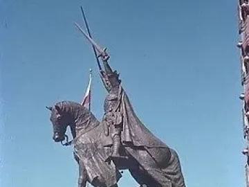 King Jagiello Monument, an equestrian bronze statue of a armored figure holding a sword aloft, with a Polish flag behind it and the word POLAND on the pedestal.