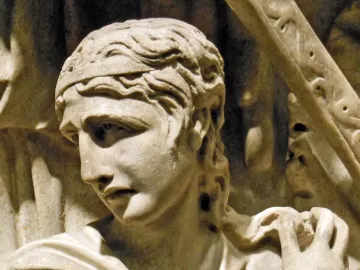 Marble relief of a wavy-haired figure from the Portonaccio Sarcophagus, shown with a downward gaze and draped garment fastened at the shoulder.