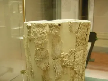 Situla of the Pania with a cream-colored cylindrical body and carved relief decoration