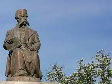 Vuk Karadžić Monument, a bronze seated statue of a man holding an open book on a stone pedestal with Cyrillic inscriptions.