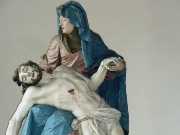 Nenningen Pietà showing a sorrowful woman cradling the body of Christ with visible wounds.