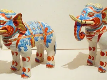 Pair of Kakiemon elephants decorated with blue and red patterns and prominent tusks.