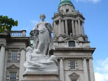 Titanic Memorial statue in Belfast, with a female figure holding a wreath above figures on a granite pedestal.