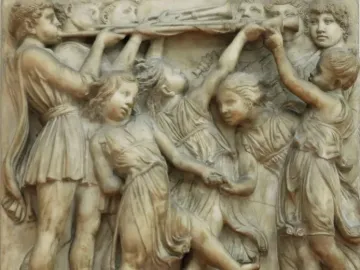 Cantoria marble relief showing young figures singing and dancing with musical instruments.