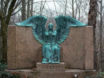 Haserot Angel bronze sculpture with outstretched wings and inverted torch atop a granite monument