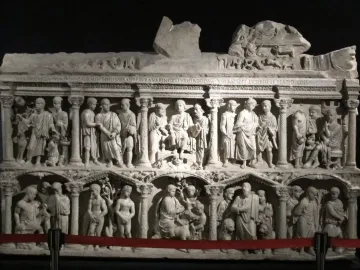 The Sarcophagus of Junius Bassus with two carved relief registers showing draped figures in architectural niches.
