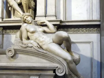 Dawn, a white marble sculpture of a reclining nude woman resting on her bent arm.
