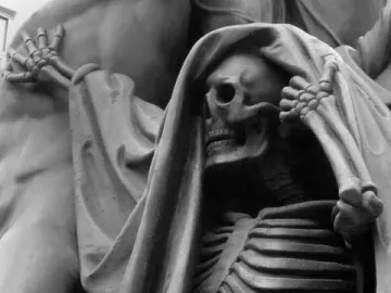 Skeletal figure from the Nelson Monument with a raised hand and flowing drapery beside a muscular form.