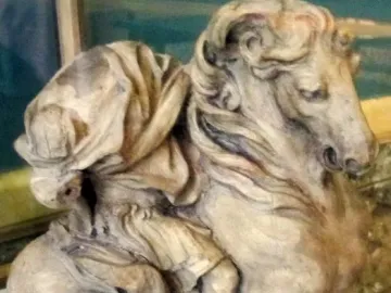 The Vision of Constantine sculpture depicted as a light-colored horse and rider with the rider’s head shrouded in drapery.