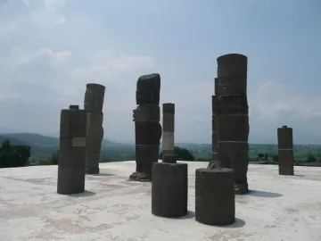 Atlantean Figures at Tula standing on a weathered platform beneath a partly cloudy sky.