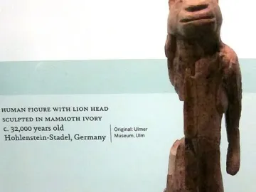 Lion-man sculpture with a lion-like head and human body standing upright.