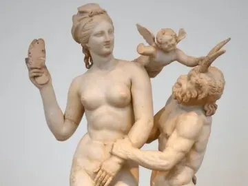 Marble sculpture of Aphrodite, Pan and Eros, with a nude woman resisting Pan as Eros pushes him away.