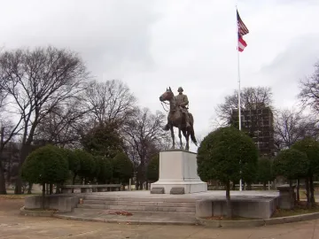 Nathan Bedford Forrest Monument showing a bronze equestrian statue on a multi-tiered pedestal in a park setting.