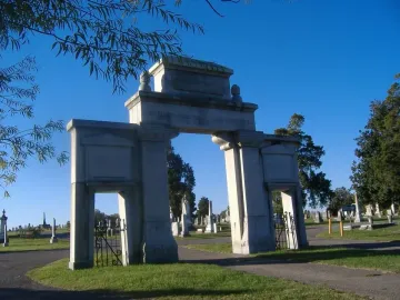 Confederate Memorial Gateway stone entrance with vehicle and pedestrian arches in a cemetery