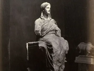 The Demeter of Knidos, a heavily draped seated statue with a tilted head and missing arms, resting on a block-like support and pedestal.