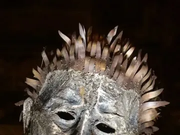 Close-up of the Knife Angel sculpture’s metallic head with hollow eyes and blade-like spikes forming the hair.