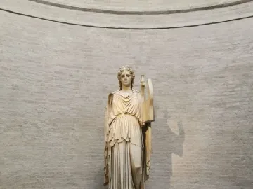 Apollo Barberini statue standing on a plinth in the Glyptothek museum, holding part of a lyre-like object