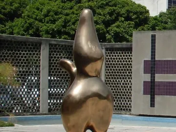 Cloud Shepherd bronze abstract sculpture with smooth organic contours on a tiled outdoor plaza.