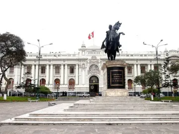 Equestrian statue of Simón Bolívar on a rearing horse in a paved plaza, with the Congress building in the background.