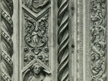 Close-up of the Porta della Mandorla showing twisted columns and carved relief panels with putti, an angel holding a scroll, and foliate ornament.