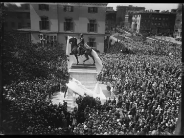 Crowd gathered around the Lafayette Monument during an unveiling ceremony, with the equestrian statue partially covered in white fabric.