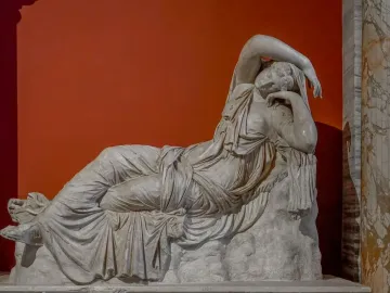Sleeping Ariadne, a white marble sculpture of a reclining woman with her head resting on her arm.