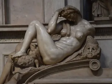 Michelangelo’s Night, a reclining marble female figure with an owl beneath her foot and a mask beside her arm.