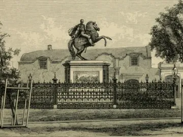 The Equestrian Statue of Simón Bolívar, showing a cloaked figure on a rearing horse atop a tall pedestal behind an ornate iron fence.