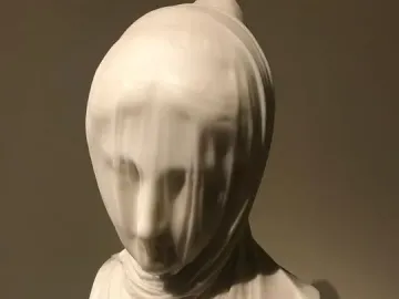 The Veiled Nun marble bust with a delicate veil covering the face and draping over the shoulders.