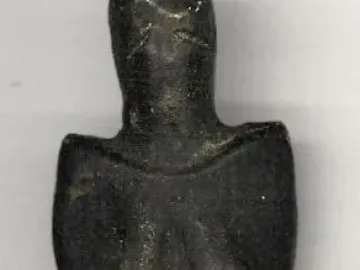 Venus of Dolní Věstonice figurine with rounded head, prominent breasts, and a full abdomen.