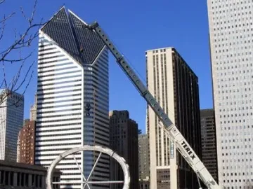 Cloud Gate’s segmented metal shell under construction with a crane overhead and Chicago buildings in the background.