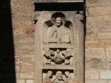 Tomb of Bruno the Priest stone relief with carved figures and vertical inscriptions