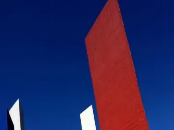 Torres de Satélite with five brightly colored geometric towers against a blue sky.