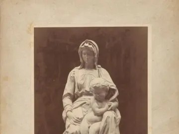 Michelangelo’s Madonna of Bruges sculpture showing the Virgin Mary seated with the Christ Child on her lap.