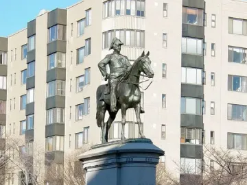 Bronze equestrian statue of Winfield Scott on a tall stone pedestal marked \