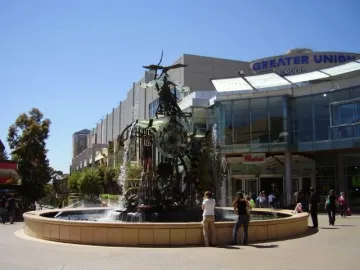 Hornsby Water Clock fountain sculpture with gears, pipes, and cascading water in a plaza
