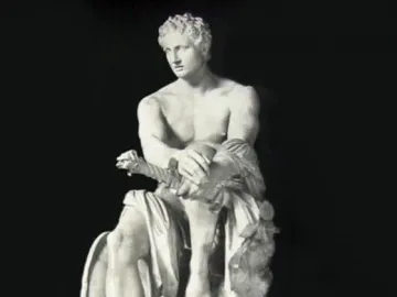 Ludovisi Ares seated on a pile of weapons with a small winged figure at his feet.