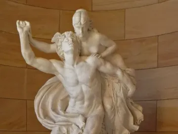 Mercury and Psyche sculpture by Reinhold Begas, showing a winged male figure and a woman beside a stone wall.