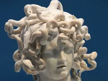 Bernini\'s Medusa, a marble bust with a downcast face and snakes carved as hair.