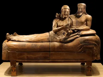 Sarcophagus of the Spouses showing a smiling man and woman reclining together on a banqueting couch.
