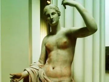 Townley Venus marble statue with one arm raised and the other extended, draped below the waist.