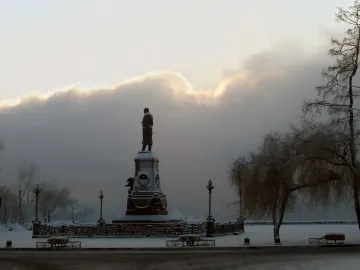 Monument of Alexander III standing on an ornate pedestal in a snowy winter landscape