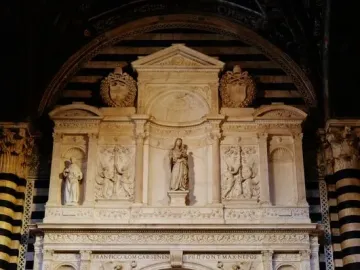 Piccolomini Altarpiece with multiple marble figures in niches and relief panels inside Siena Cathedral.