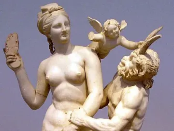 Aphrodite, Pan and Eros marble sculpture showing a nude woman holding up a sandal as Pan reaches toward her and a winged child pushes his head away.