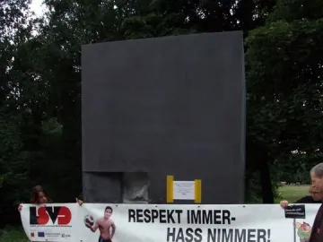 The Memorial to Homosexuals Persecuted Under Nazism with a protest banner reading \