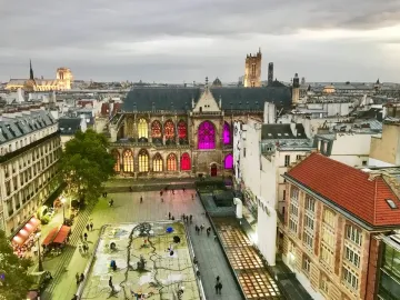 Stravinsky Fountain with colorful abstract sculptures in a rectangular basin in a city square.