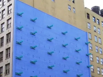 The Wall by Forrest Myers, showing a bright blue wall with teal angled forms arranged in a grid.
