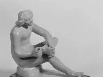 Boy with Thorn statue of a nude youth seated and looking down at his raised foot