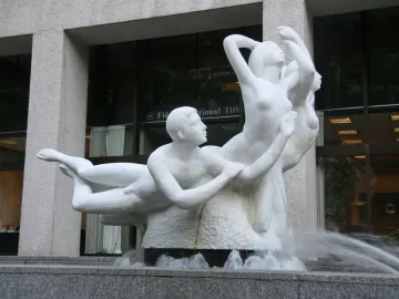 The Quest sculpture, a white marble fountain with nude figures and water flowing into a granite basin.
